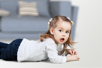 Lying on floor. Little smiling cute child. Concept of emotions, facial expressions.