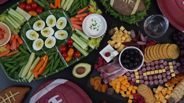 Party table with food and drink for watching american football game.