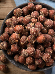 hazelnuts in shells with salt on a wooden background. a pile or stack of hazelnuts. Hazelnut background, healthy food.