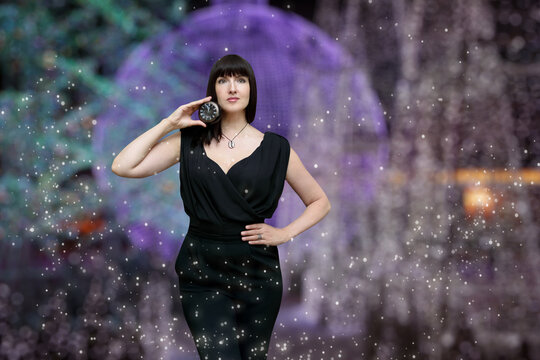 Festive christmas background with bright lights and a woman in a fashionable suit
