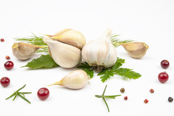 Garlic heads, pepper mixture, cranberry berries, bay leaf and dill isolated on white background.