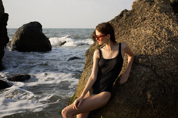 pretty woman in swimsuit island rocks posing summer