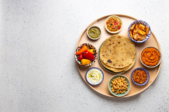 Indian Thali - Assorted vegetarian meze with boiled basmati rice, paneer, dal and chutney