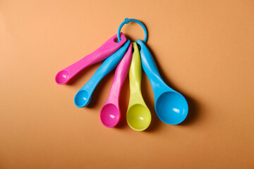 Cooking measuring spoons, top view, on orange background