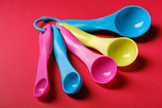 Cooking measuring spoons, on a red background, close up