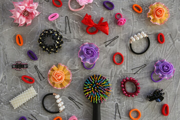 Different hair clips on gray background. Flat lay. Top view.