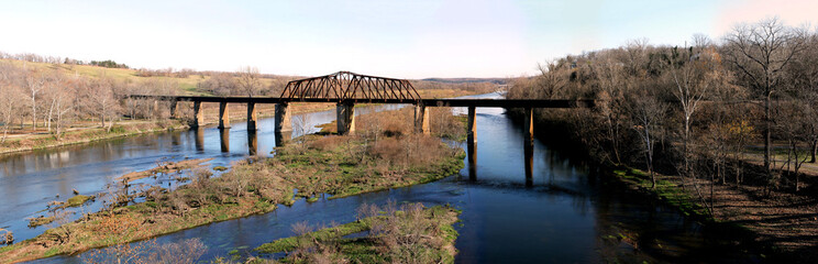 Historic iron swing bridge over the White River, near Cotter Arkansas. Old steel truss bridge built in 1905, stretches 285 feet long.