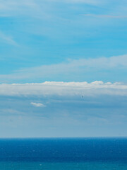 Panoramic view of bright blue sea, blue sky with fluffy white clouds