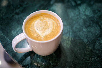 Coffee cup in coffee shop, hot Latte fresh coffee with lattw art in white cup on table in cafe