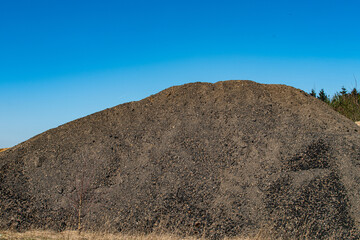 Piles of bulk industrial sand and gravel material
