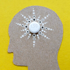 LSD pill in the head of the human brain, hallucinogenic trip insight and epiphany
