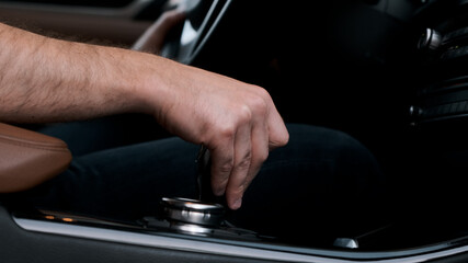 Man shifts gears with joystick with one hand