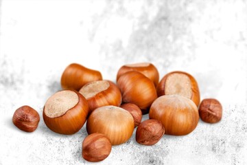 Hazelnuts on background is small round brown hard-shelled nut that is the edible fruit of hazel.