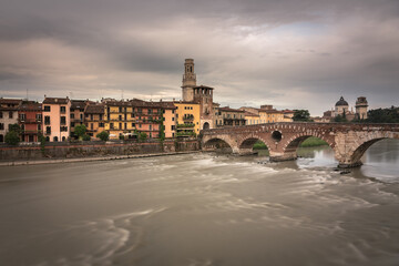 Obraz premium The famous Stone Bridge (Ponte di Piettra) over Adige river in Verona old town in a stormy day, Verona, Veneto Region, Italy