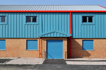 Facade and Shuttered Entrance to Modern Blue Industrial Building 