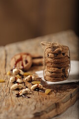Stack of cookies tied with thread and placed on table with group of Cashew & Chocolate