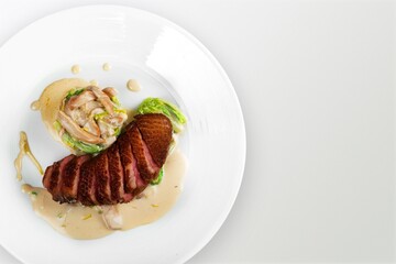Tasty fresh steak with baked vegetables on white plate. Meat steak medium rare roasted