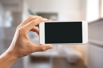 Hands hold smartphone with blank screen