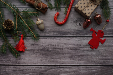 Fir branches and Christmas toys on a wooden photophone.