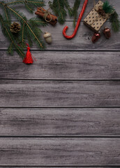 Fir branches and Christmas toys on a wooden photophone.