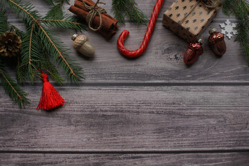 Fir branches and Christmas toys on a wooden photophone.