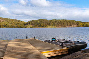 Pier and motor boat on the lake of Ladoga. Karelia, Russia