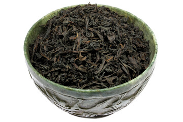 Ceylon Black Tea in a vintage jade bowl isolated on white background