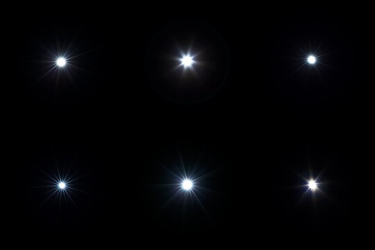 Set of flash lights with lens flare effect on black background