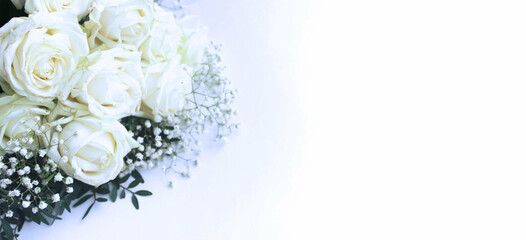 A chic festive bouquet of white roses on a white background. Beautiful flowers. The bride's bouquet. Background for greeting cards, invitations, greetings.