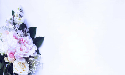 Fototapeta premium Delicate bouquet of white peonies on a white background. The bride's bouquet, a festive floral arrangement. Background for a greeting card.