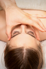 Obraz na płótnie Canvas Face massage with fingers of a masseur. Female facial skin care at a beauty spa salon