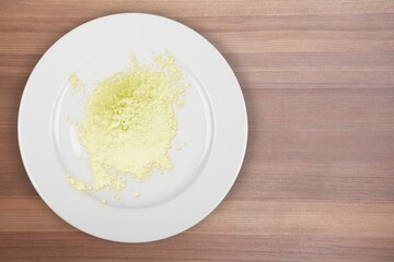 Colored chemical ingredients on the laboratory table. Sulfur Powder in Chemical Watch Glass