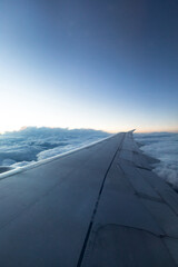 Fototapeta na wymiar beautiful view of the plane wing, blue clouds and sunset