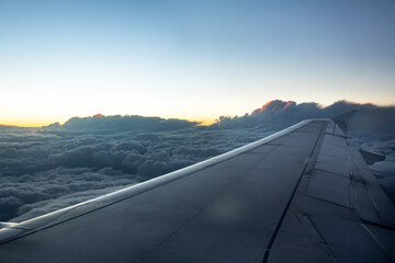 Fototapeta na wymiar beautiful view of the plane wing, blue clouds and sunset