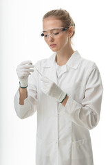 The girl laboratory assistant shows an indicator tube with the result of the analysis. Laboratory assistant in a medical laboratory or a petroleum product quality laboratory