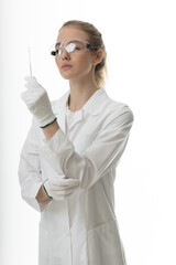 The girl laboratory assistant shows an indicator tube with the result of the analysis. Laboratory assistant in a medical laboratory or a petroleum product quality laboratory