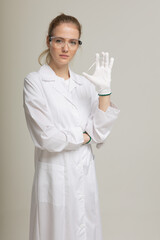 The girl laboratory assistant shows an indicator tube with the result of the analysis. Laboratory assistant in a medical laboratory or a petroleum product quality laboratory