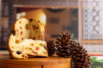Delicious panettone with candied fruit, cut into pieces for Christmas, approximate photo