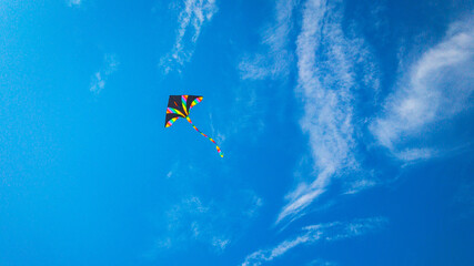 Kite sky. Colorful high flying toy. Air kite fly on blue wind background. Rainbow kite in summer...