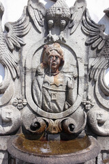 Extraordinary stone fountain bowl in the form of water from eyes tubes pipe of crying woman. Sanctuary Bom Jesus do Monte,  Braga, Portugal. Christian pilgrimage site with monumental baroque stairway 