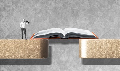 Open book bridging the gap between blocks for human miniature figure to cross