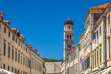 Fototapeta na wymiar Tower of Franciscan Church and Monastery on Stradun street in the historic city center of Dubrovnik in Croatia, Europe.