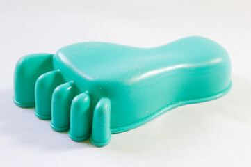 Toy foot made of green plastic