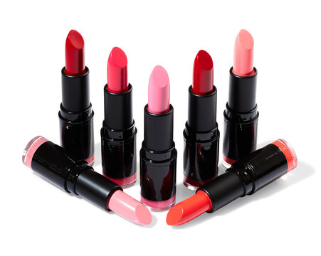 Bright Red And Pink Lipsticks Over White Background