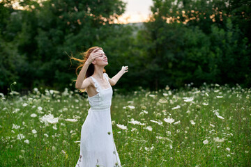 Woman in a white dress in a field on nature flowers freedom summer