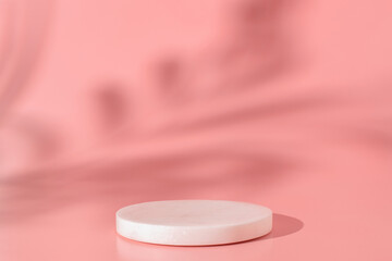 White marble podium on the pink background with shadow of tropical plant. Podium for product,...