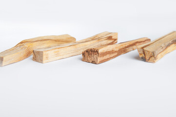 Palo Santo bars close-up and copy space. Ritual cleansing with sacred ibiocai, meditation, aromatherapy with incense and candles..