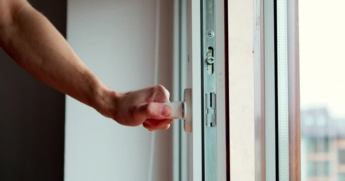 The worker installing and checking window in the house