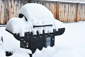 An image of a snow covered barbeque after a winter snow storm. 
