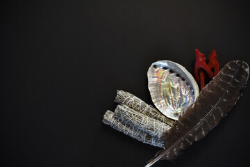 Fototapeta premium A top view image of a healing smudge kit on a black background. 